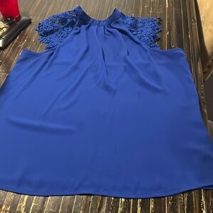 Blue lace top. Resists wrinkles and is perfect for work or going out.